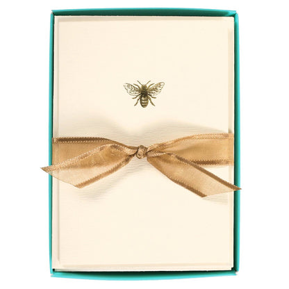 La Petite Presse Bee Boxed Notes, A cream notecard with a single gold foil bee icon, tied with a gold ribbon inside a teal box.