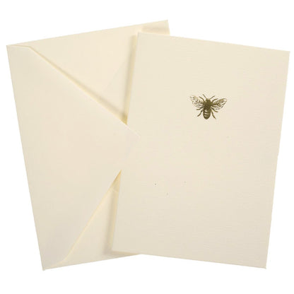 La Petite Presse Bee Boxed Notes, A cream notecard with a single gold foil bee icon, tied with a gold ribbon inside a teal box.