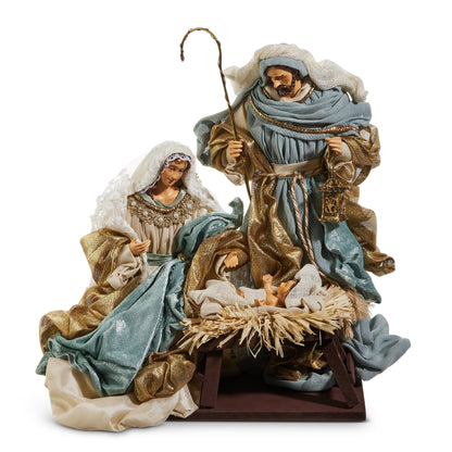 Blue and Gold Holy Family Nativity Figure, A Holy Family nativity in blue and gold cloth robes, with Mary in a lace veil beside the manger and Joseph holding a shepherd's crook and a lantern on a dark base.