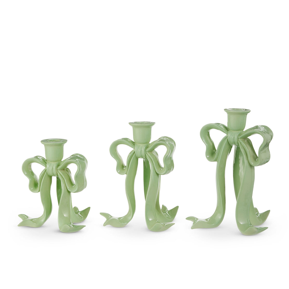 Bow Taper Candlestick, Three graduated sage green resin candlesticks shaped like tied ribbon bows, each with a taper candle holder at the top.