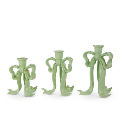 Bow Taper Candlestick, Three graduated sage green resin candlesticks shaped like tied ribbon bows, each with a taper candle holder at the top.