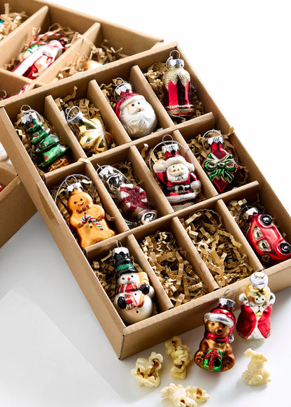 Box of Traditional Christmas Ornaments, A box of twelve miniature glass Christmas ornaments including a bear, gifts, Santa figures, a star, a snowman, an angel, a tree, and a gingerbread man, each in a padded compartment.