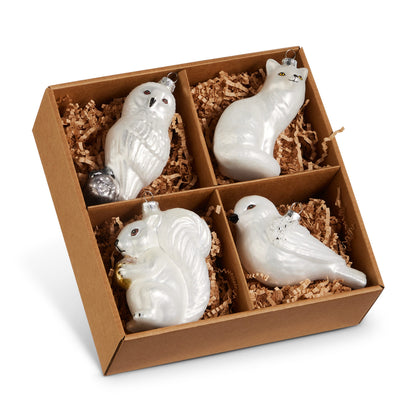 Box of Winter Woodland Animal Ornaments, A box of four pearl white glass ornaments shaped like an owl, a fox, a squirrel and a bird, each with silver or gold accents.