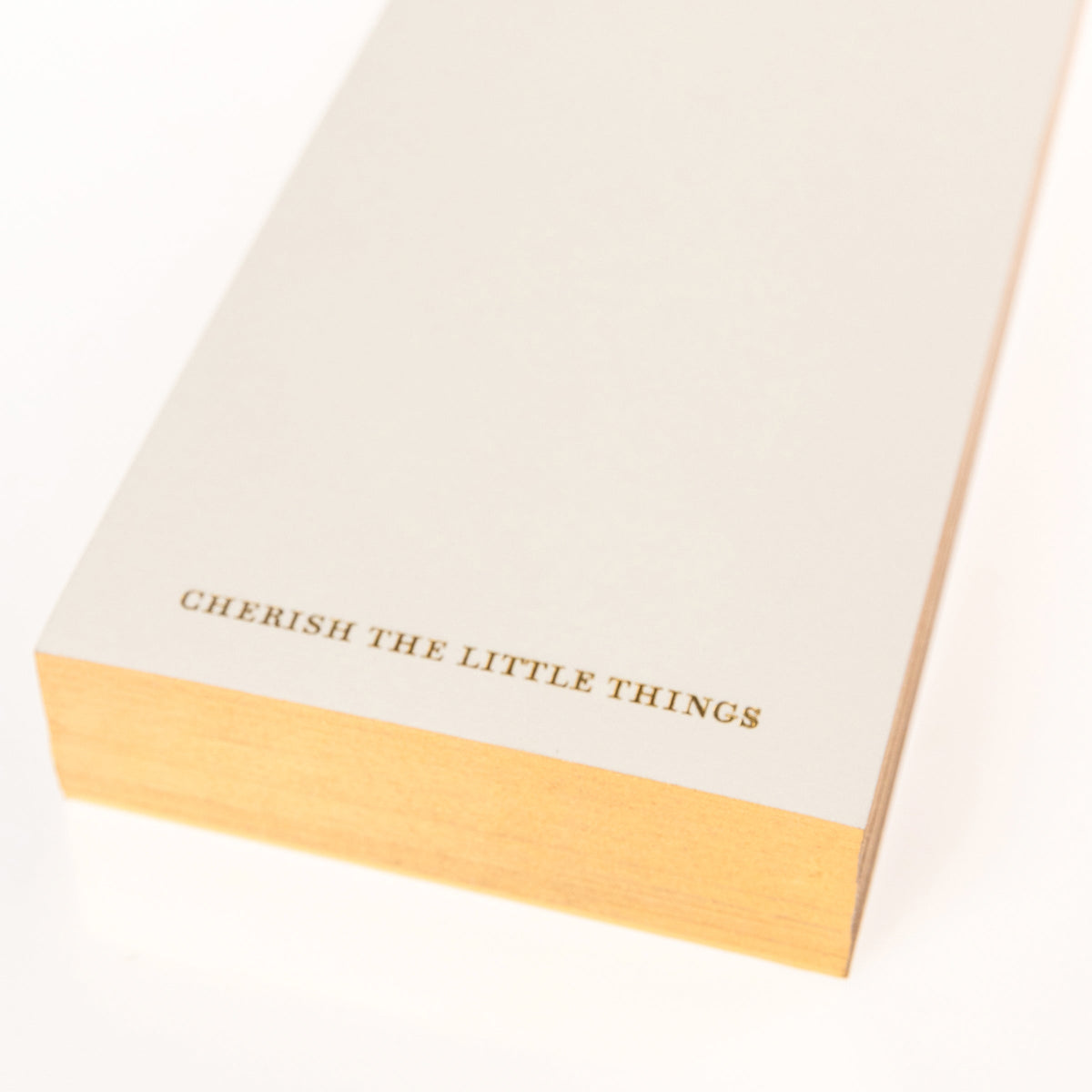 La Petite Presse Cherries Gilded Desktop Notepad, A cream notepad with gold foil cherries at the top and the words Cherish the Little Things stamped in gold at the bottom.