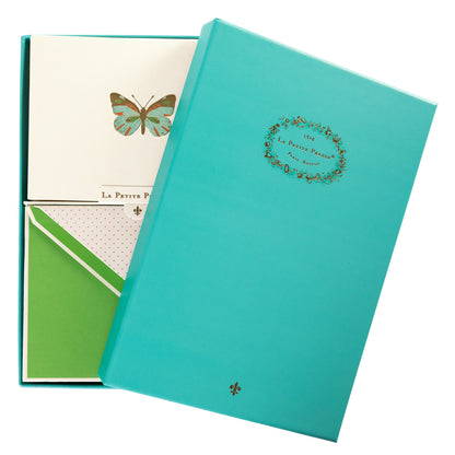 La Petite Presse Butterfly Boxed Correspondence Notes, A cream notecard with a colorful teal, orange, and brown foil butterfly, paired with a bright green lined envelope in an open teal gift box.