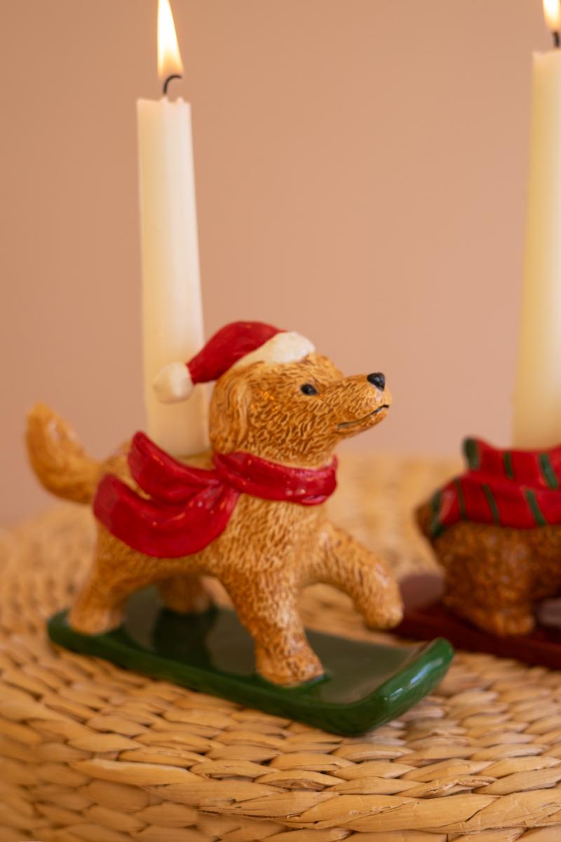 Ceramic Christmas Dog Taper Candle Holder, Five ceramic dog figures in holiday scarves, each holding a taper candle, lined up in a row.