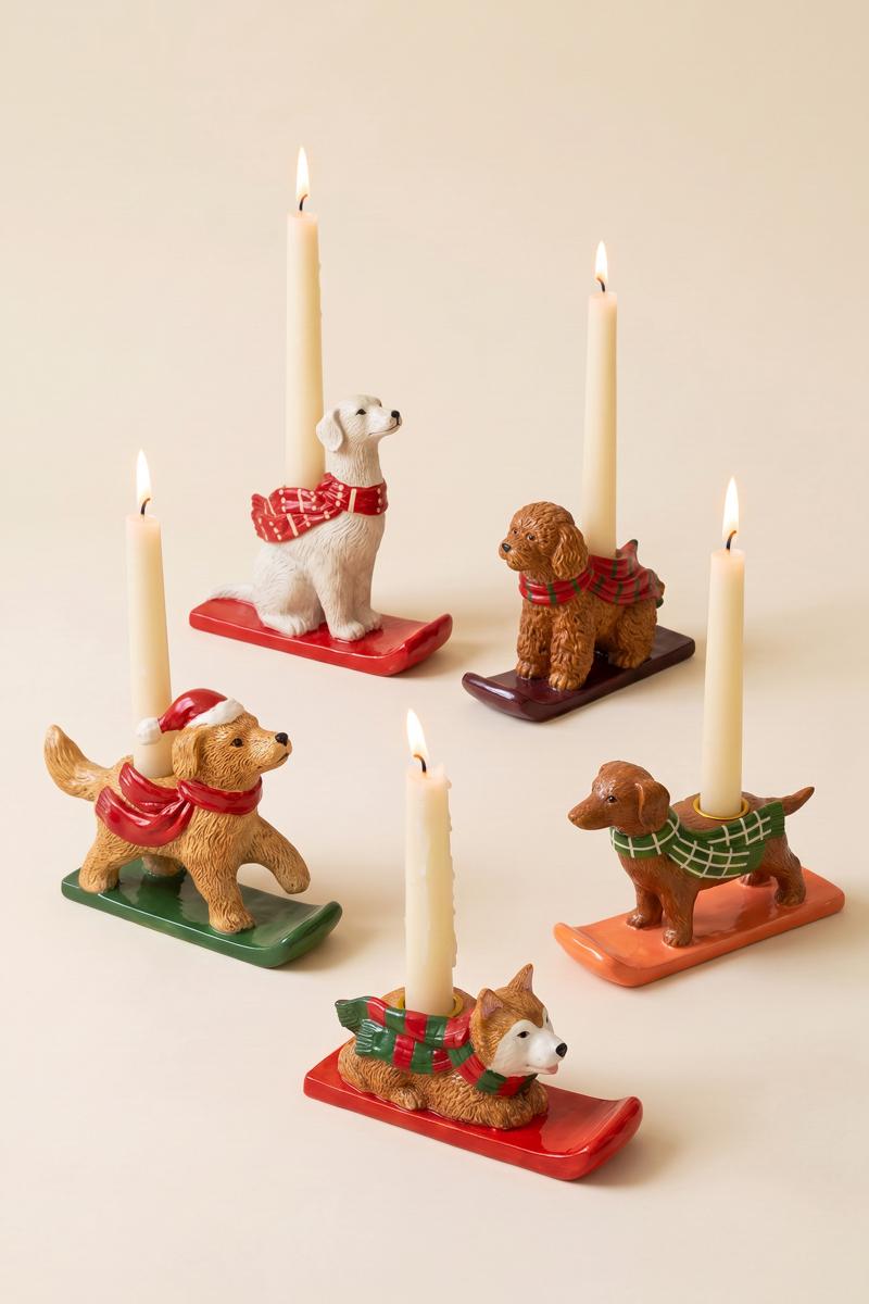 Ceramic Christmas Dog Taper Candle Holder, Five ceramic dog figures in holiday scarves, each holding a taper candle, lined up in a row.