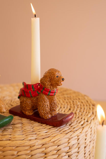Ceramic Christmas Dog Taper Candle Holder, Five ceramic dog figures in holiday scarves, each holding a taper candle, lined up in a row.