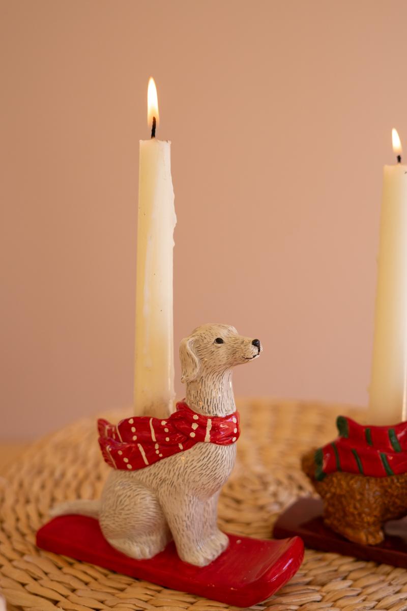 Ceramic Christmas Dog Taper Candle Holder, Five ceramic dog figures in holiday scarves, each holding a taper candle, lined up in a row.