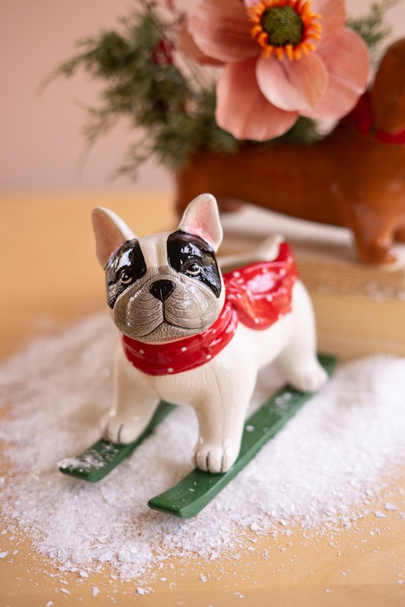 Ceramic Christmas Skiing Dog Planter, A glossy ceramic dog figure on skis with a planter opening in its back.