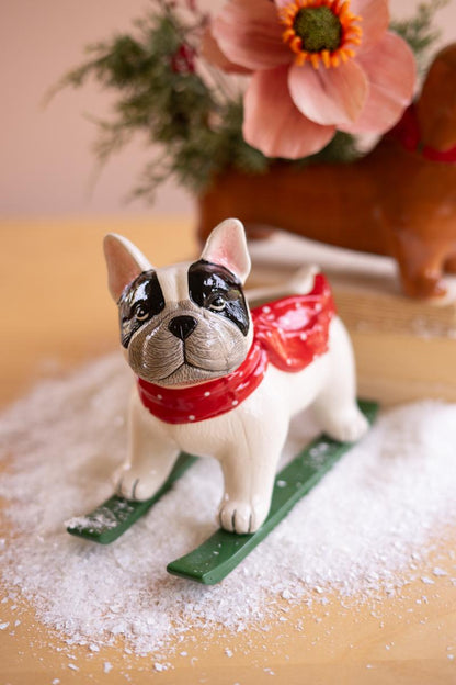 Ceramic Christmas Skiing Dog Planter, A glossy ceramic dog figure on skis with a planter opening in its back.