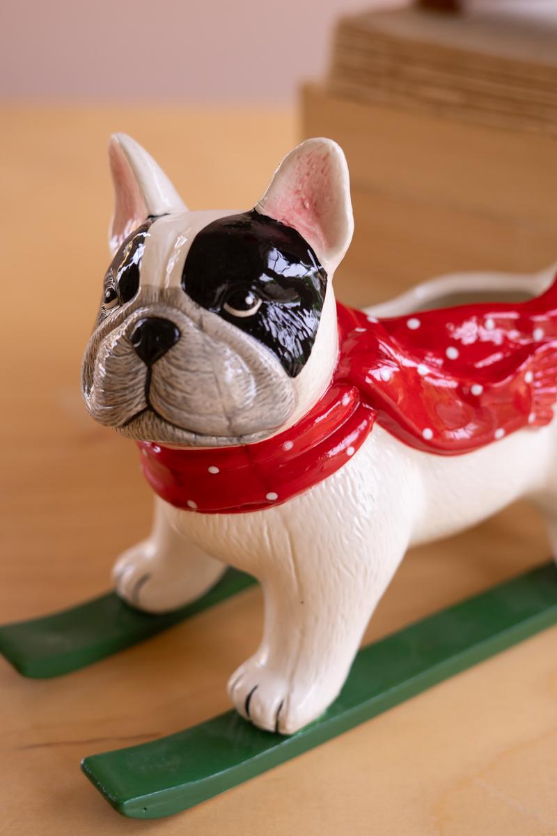 Ceramic Christmas Skiing Dog Planter, A glossy ceramic dog figure on skis with a planter opening in its back.