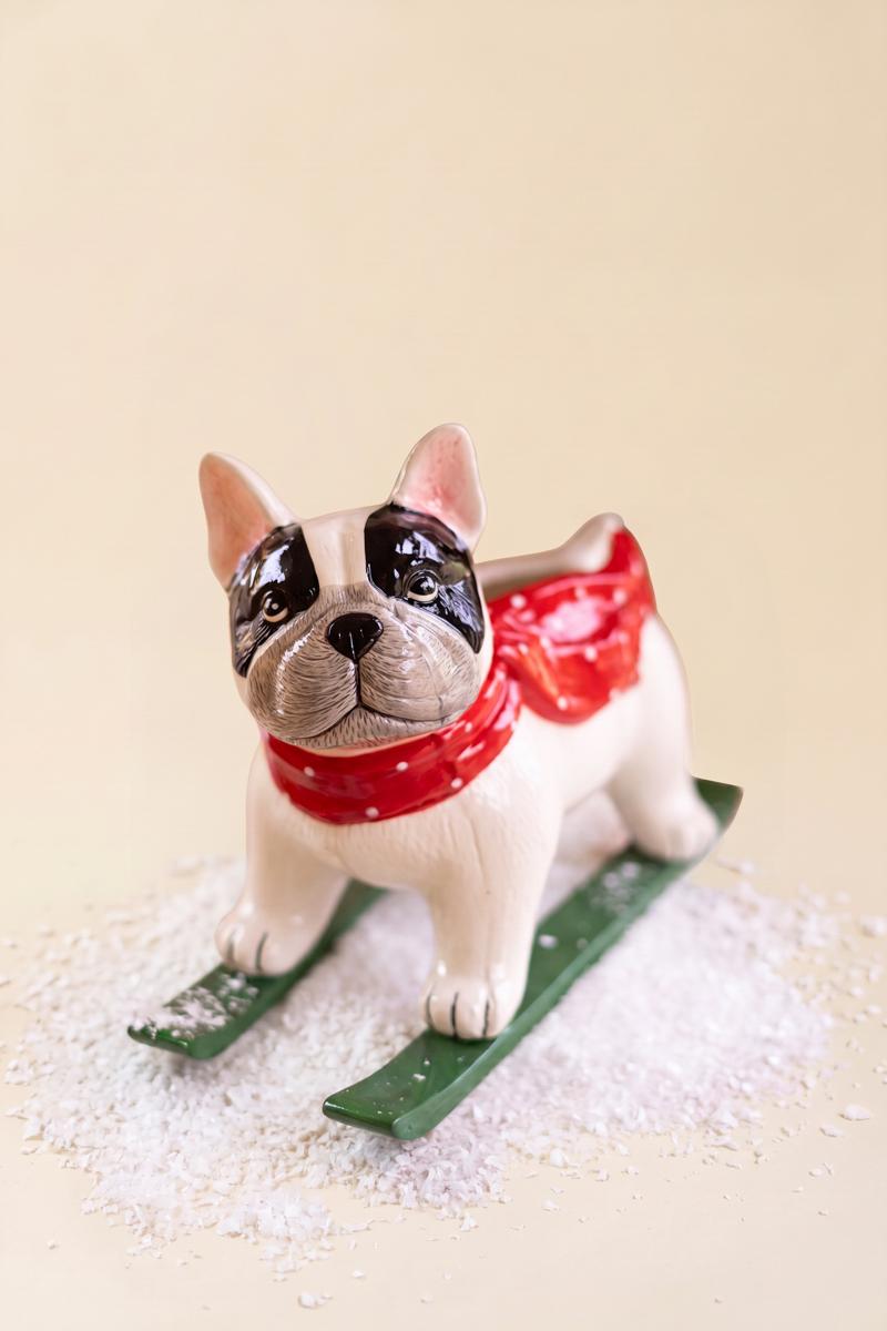 Ceramic Christmas Skiing Dog Planter, A glossy ceramic dog figure on skis with a planter opening in its back.