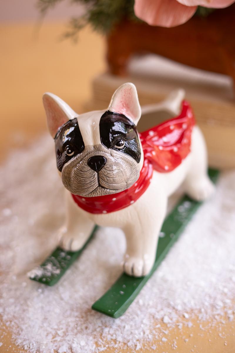 Ceramic Christmas Skiing Dog Planter, A glossy ceramic dog figure on skis with a planter opening in its back.