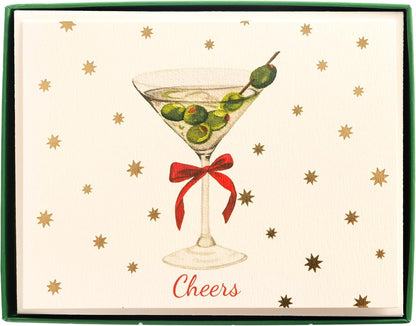 Cheers Holiday Cards, Box of 15, A cream holiday card with a martini glass, green olives and a red bow under gold foil stars and Cheers in red script, set in its green box.