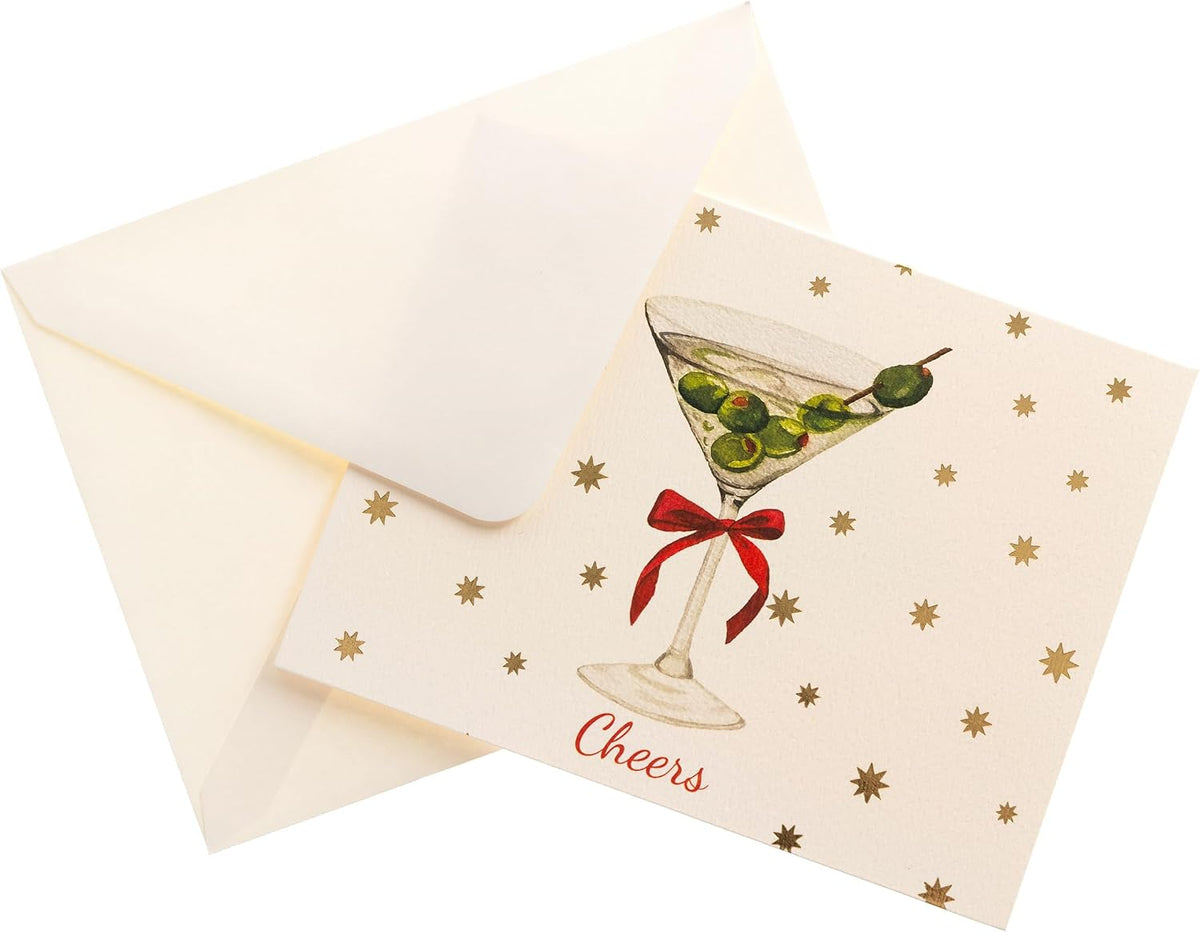 Cheers Holiday Cards, Box of 15, A cream holiday card with a martini glass, green olives and a red bow under gold foil stars and Cheers in red script, set in its green box.