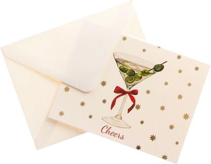 Cheers Holiday Cards, Box of 15, A cream holiday card with a martini glass, green olives and a red bow under gold foil stars and Cheers in red script, set in its green box.