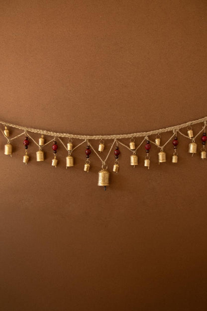 Christmas Bell Garland with Wood Beads, A garland of hanging metal bells strung with wood beads on jute cord.