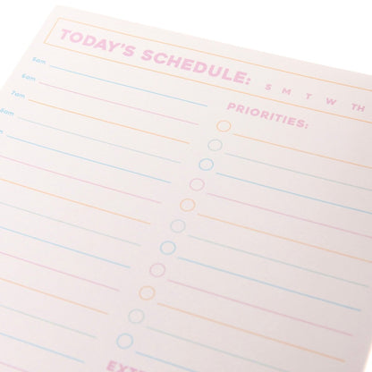 Colorful Cream Notepad Trio, Three notepads fanned together, a WORK: checklist pad in front of a lined pad with a month and date strip and a TODAY'S SCHEDULE pad, with pink headings and pink, orange and blue lines.