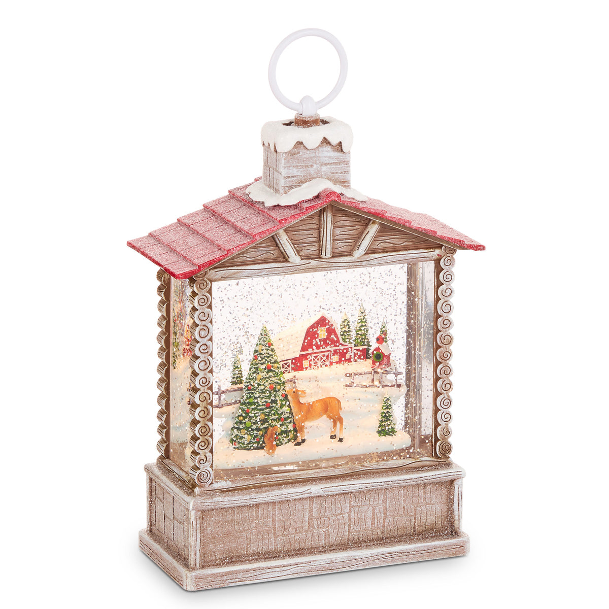 Country Christmas Lighted Water Cabin, Log cabin water lantern with a red roof and snowy chimney, showing a red barn, a deer by a decorated tree and a cardinal on a birdhouse.