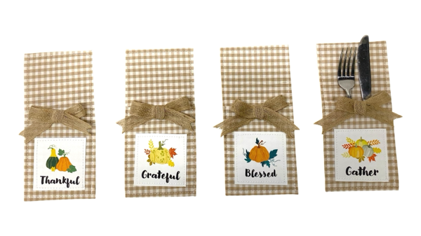 Country Thanksgiving Utensil Pockets, Set of Four, Four tan gingham utensil pockets with jute bows and printed patches reading Thankful, Grateful, Blessed and Gather, one holding a fork and knife.