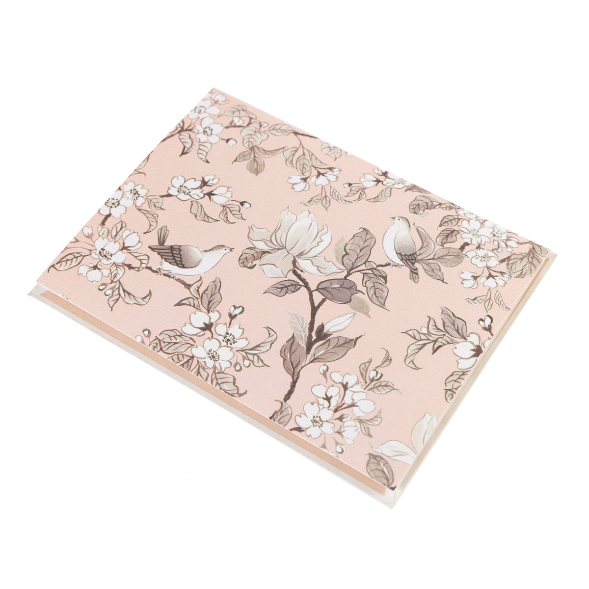 La Petite Presse Birds Boxed Correspondence Notes, A brown gift box open to a blush pink notecard printed with songbirds perched among magnolia blossoms, paired with a matching blush envelope.