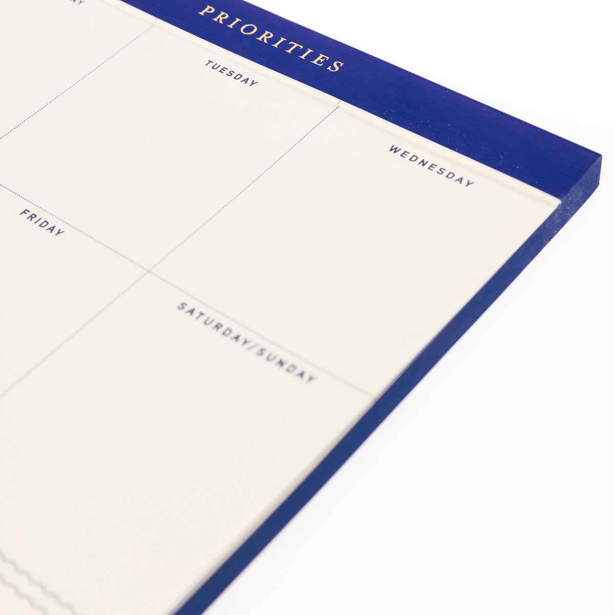 Cobalt Blue Legal Pad, A cream weekly planning pad with a cobalt blue header reading Priorities and a Monday through Sunday grid.