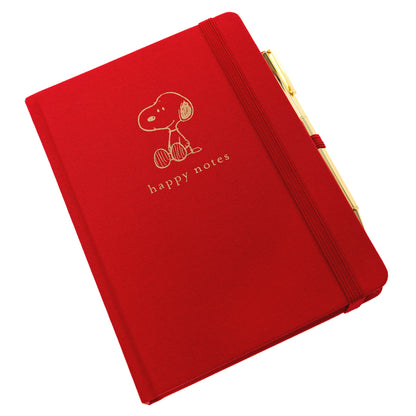 Peanuts Fabric-Bound Journal with Pen, A red fabric journal with a gold foil Snoopy illustration and the words happy notes, paired with a gold pen tucked into a loop along the spine.