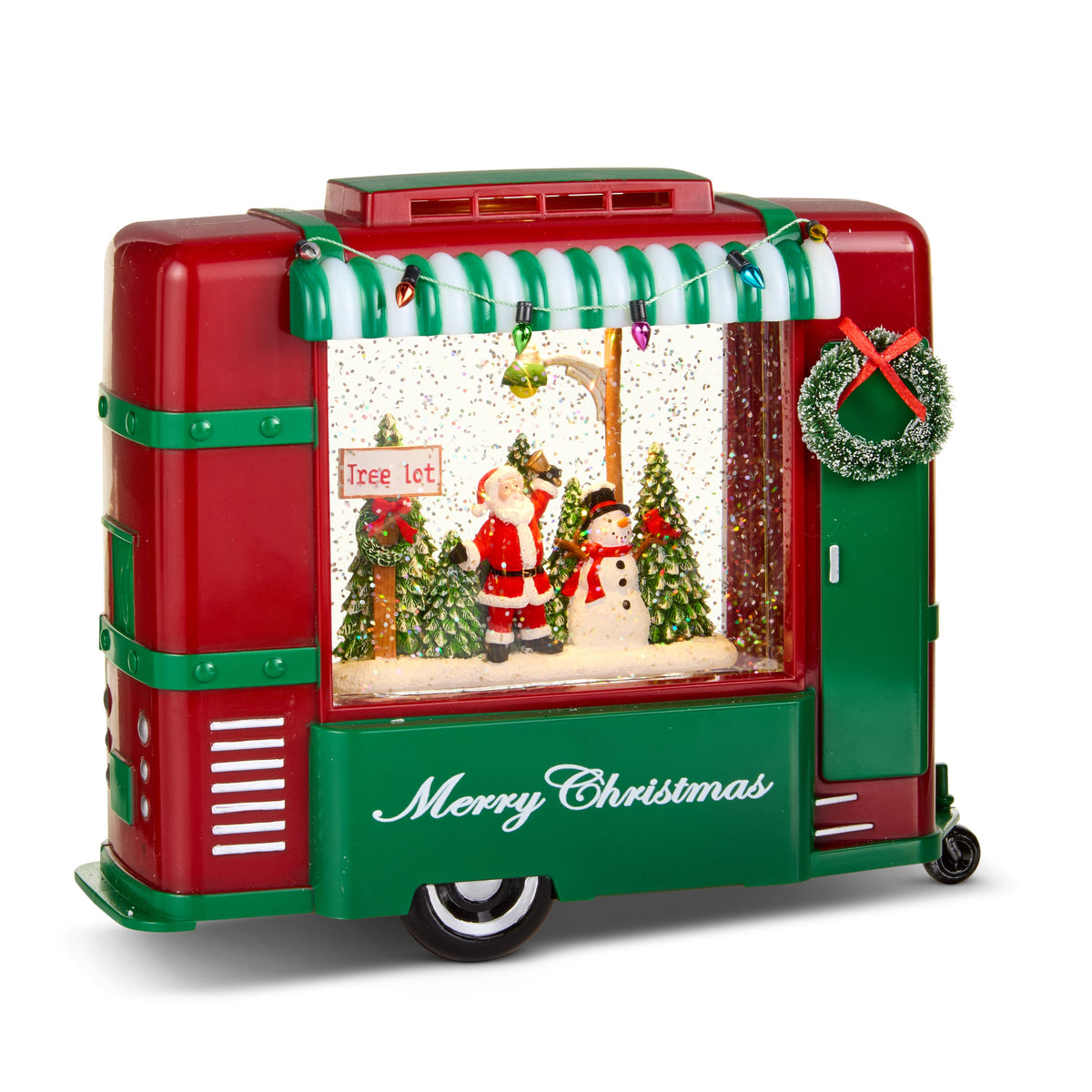 Evergreen Gathering Lighted Water Camper, Red and green vintage-style camper water lantern with a striped awning, a wreath on the door and Santa with a snowman at a tree lot inside.