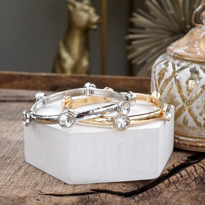 Brazalete de cristales transparentes brillantes en tono dorado o plateado.