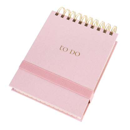 Blush Fabric-Bound Notepad, A blush pink fabric notepad with a gold foil to Do cover and a twin wire spiral binding.