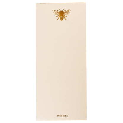 La Petite Presse Bee Gilded Desktop Notepad, A cream notepad with a gold foil bee at the top and the words Busy Bee stamped in gold at the bottom, with a gold gilded edge.