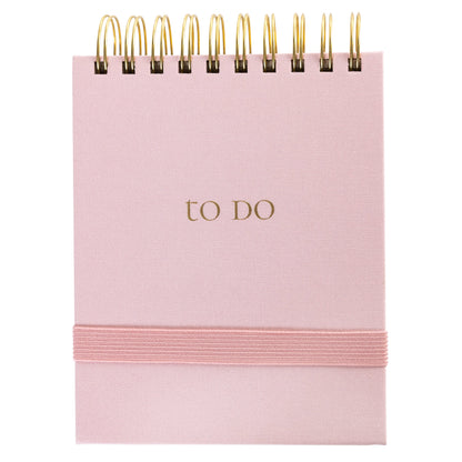 Blush Fabric-Bound Notepad, A blush pink fabric notepad with a gold foil to Do cover and a twin wire spiral binding.