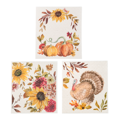 Fall Reusable Dish Cloth, Three square dish cloths printed with a Happy Fall leaf wreath, a mushroom and pinecone bouquet and a scatter of autumn leaves.