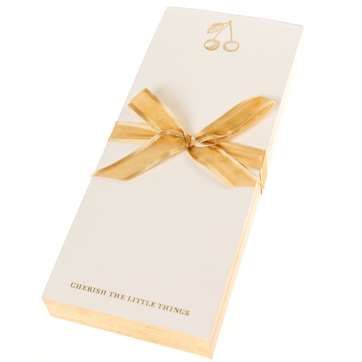 La Petite Presse Cherries Gilded Desktop Notepad, A cream notepad with gold foil cherries at the top and the words Cherish the Little Things stamped in gold at the bottom.