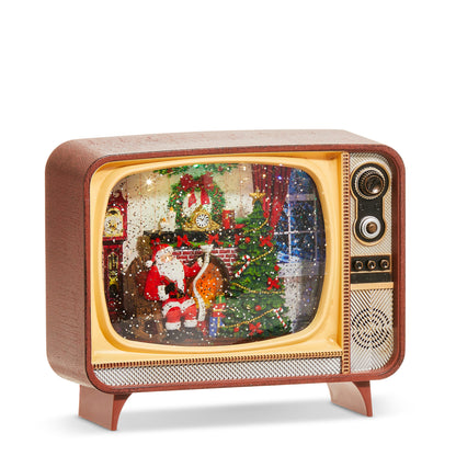 Fireplace Santa Musical Lighted Water TV, A vintage-style television shaped water lantern showing a glitter filled scene of Santa reading a list by a decorated fireplace and Christmas tree.