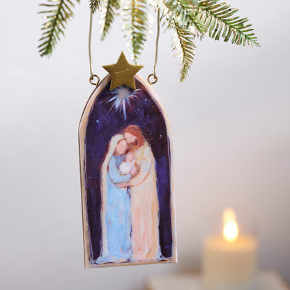 First Christmas Ornament, An arch-shaped ornament printed with an image of the Holy Family beneath a star, topped with a gold star accent.