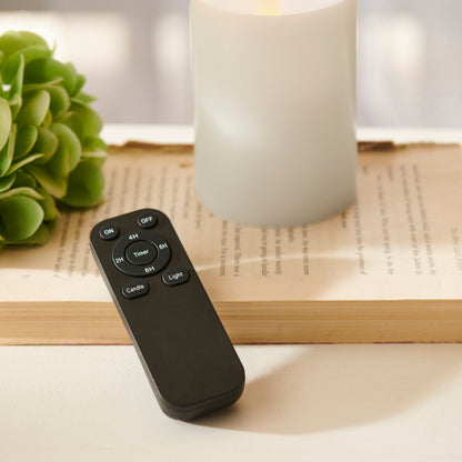 Flameless Candle Remote Control with Timer, A black handheld remote with nine labeled keys: On and Off at the top, a round Timer key ringed by 2H, 4H, 6H and 8H, and Candle and Light keys below.