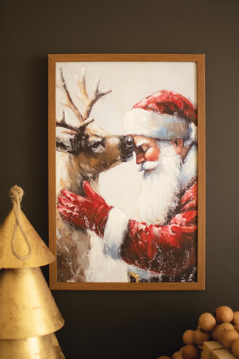 Framed Santa with Deer Painting, A framed painting of Santa standing beside a deer in a winter scene.