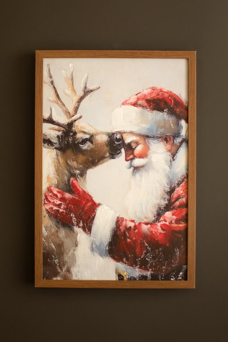Framed Santa with Deer Painting, A framed painting of Santa standing beside a deer in a winter scene.