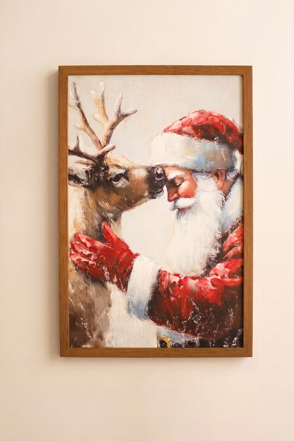 Framed Santa with Deer Painting, A framed painting of Santa standing beside a deer in a winter scene.