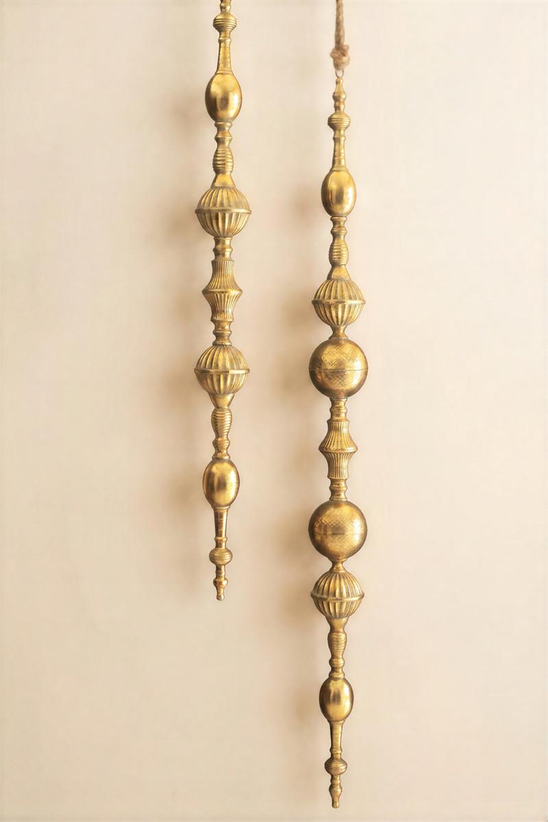 Giant Metal Christmas Finial, Two tall hanging metal finials in a distressed gold finish, one longer than the other.