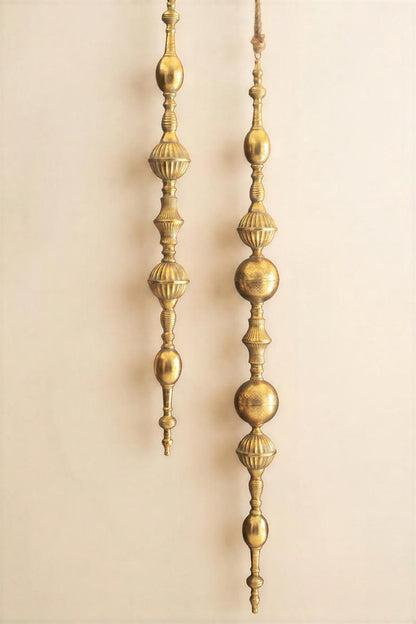 Giant Metal Christmas Finial, Two tall hanging metal finials in a distressed gold finish, one longer than the other.