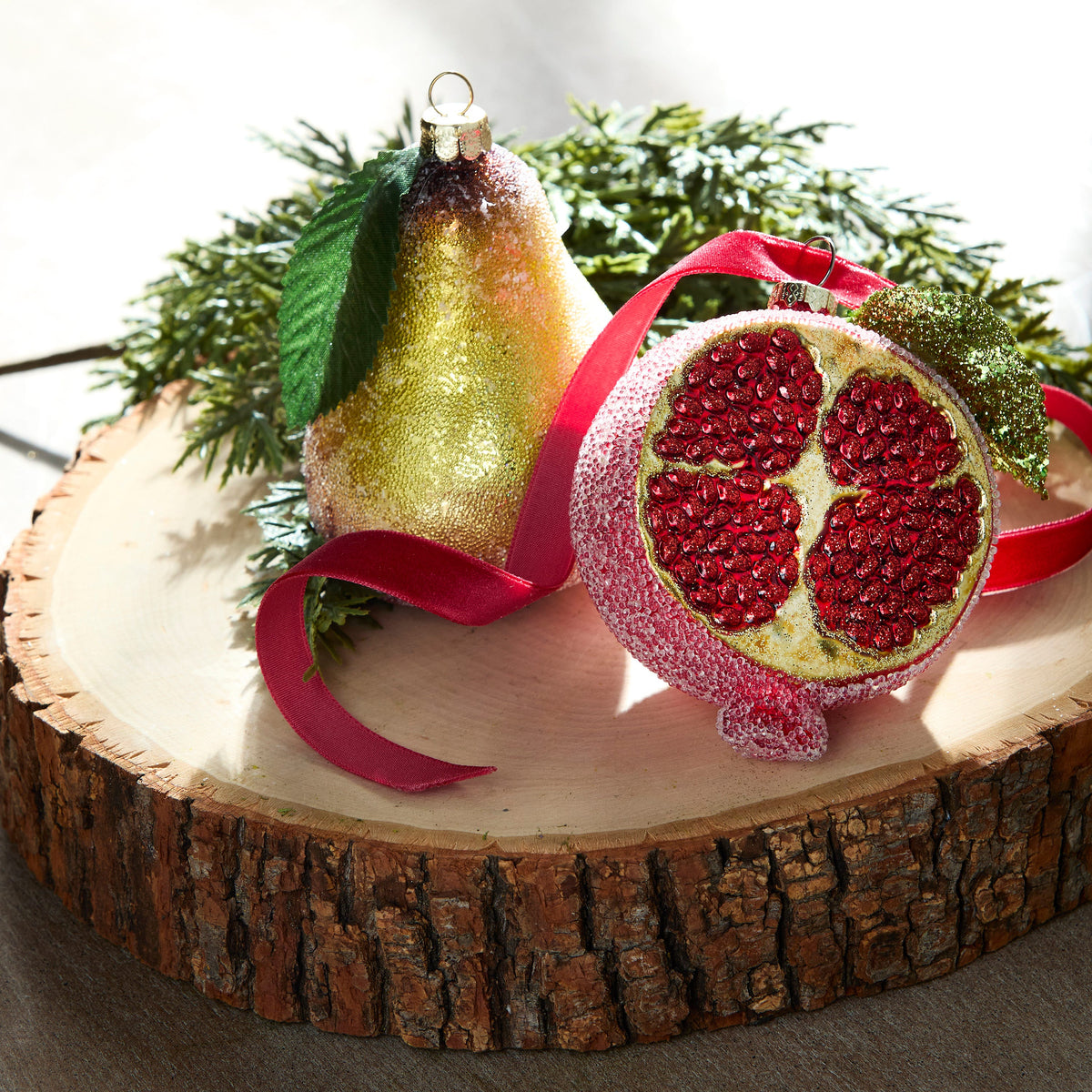 Glittered Pear Ornament, A glass pear ornament with a gold to red glitter gradient and a small green leaf at the stem.