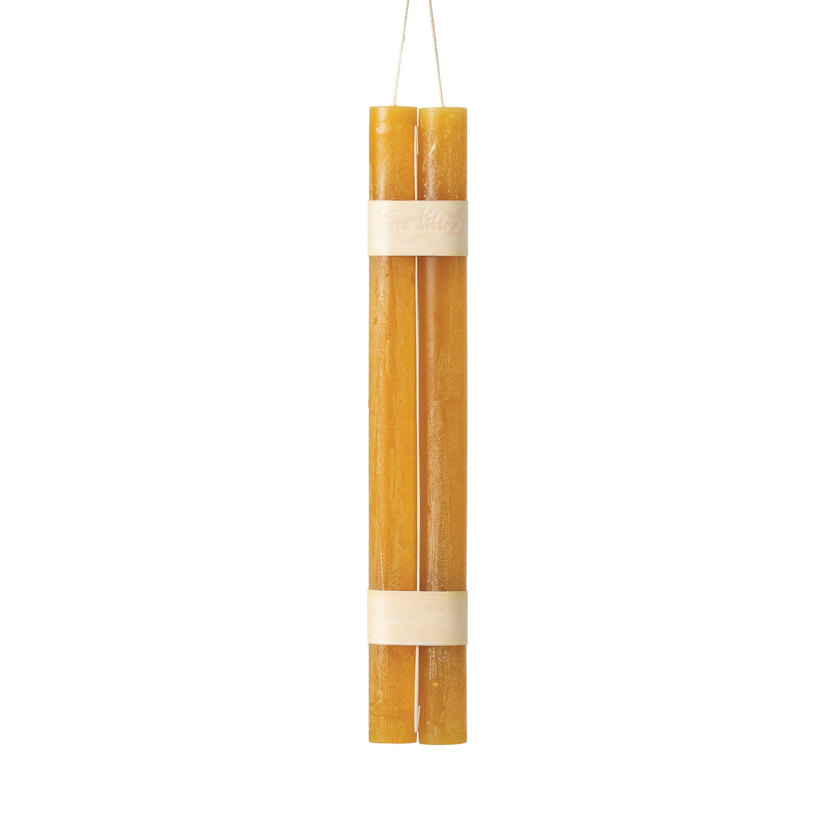Hanging Timber Taper Candles 12 Inch, Pair, Two amber colored taper candles bound together with cream paper bands hang side by side against a plain white background.
