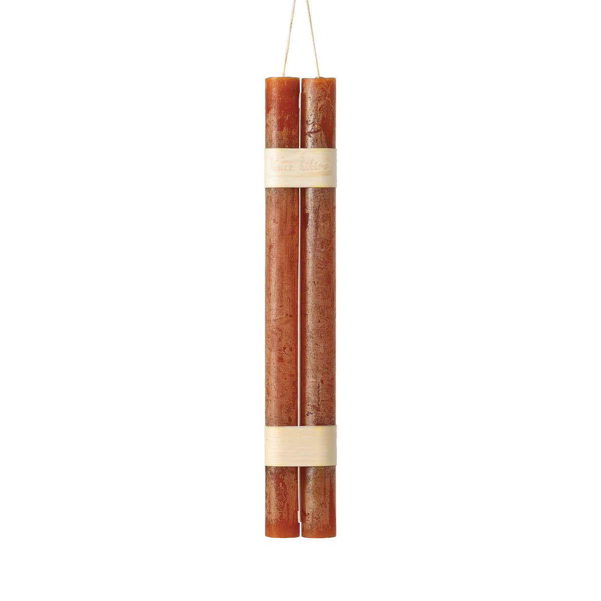 Hanging Timber Taper Candles 12 Inch, Pair, Two amber colored taper candles bound together with cream paper bands hang side by side against a plain white background.