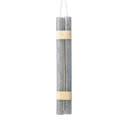 Hanging Timber Taper Candles 12 Inch, Pair, Two amber colored taper candles bound together with cream paper bands hang side by side against a plain white background.