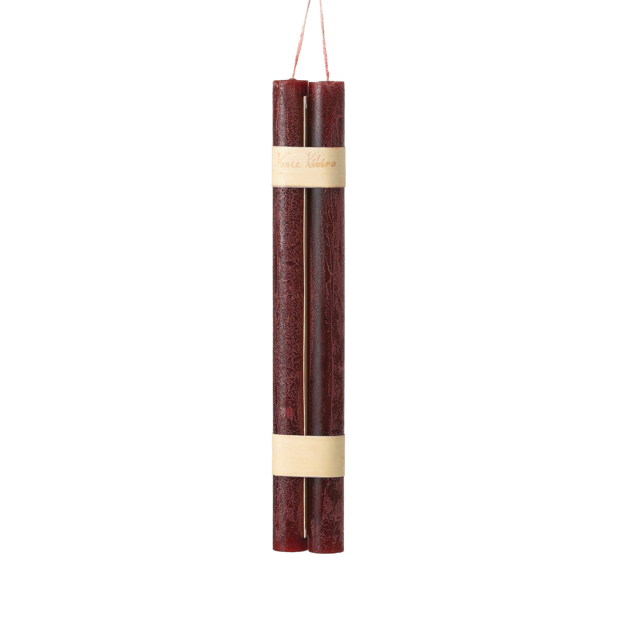 Hanging Timber Taper Candles 12 Inch, Pair, Two amber colored taper candles bound together with cream paper bands hang side by side against a plain white background.