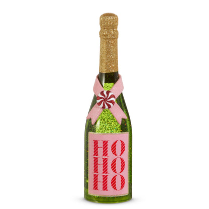 Ho Ho Ho Pink and Green Lighted Glitter Bottle, A green lighted bottle filled with green glitter, with a neck coated in gold glitter, a pink ribbon crossed under a peppermint candy, and a pink label printed with HO HO HO in red striped letters.
