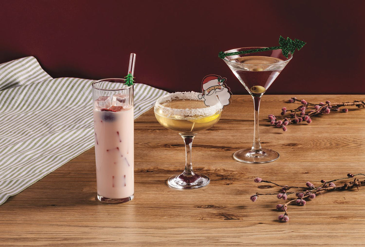 Holiday Bar Cocktail Accessories, Three kraft cards of holiday bar accessories: glass straws, icon drink markers and glitter drink stirrers in a wooden crate.